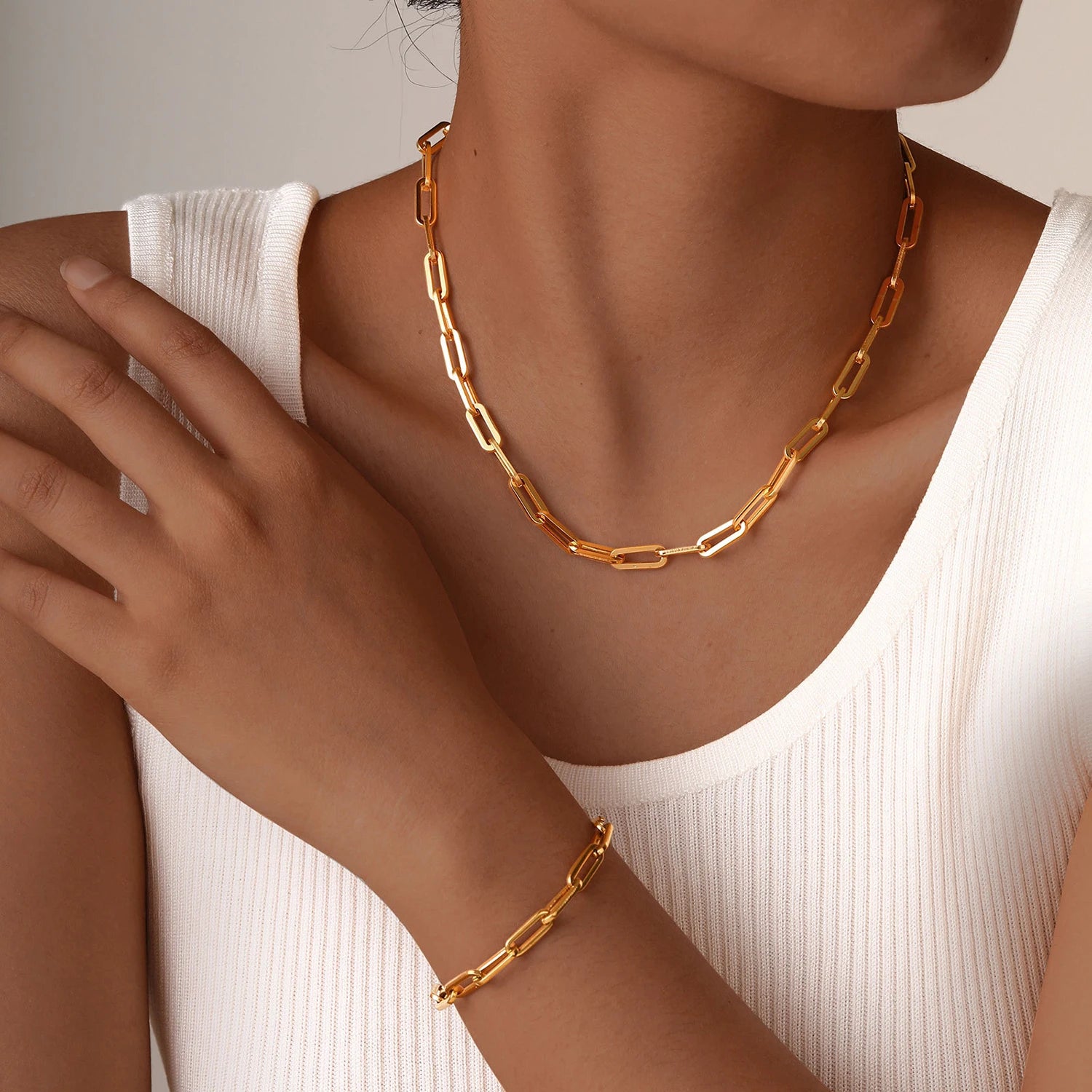Woman wearing minimalist gold chain necklace and paperclip bracelet set – PVD gold-plated stainless steel, waterproof and tarnish-resistant